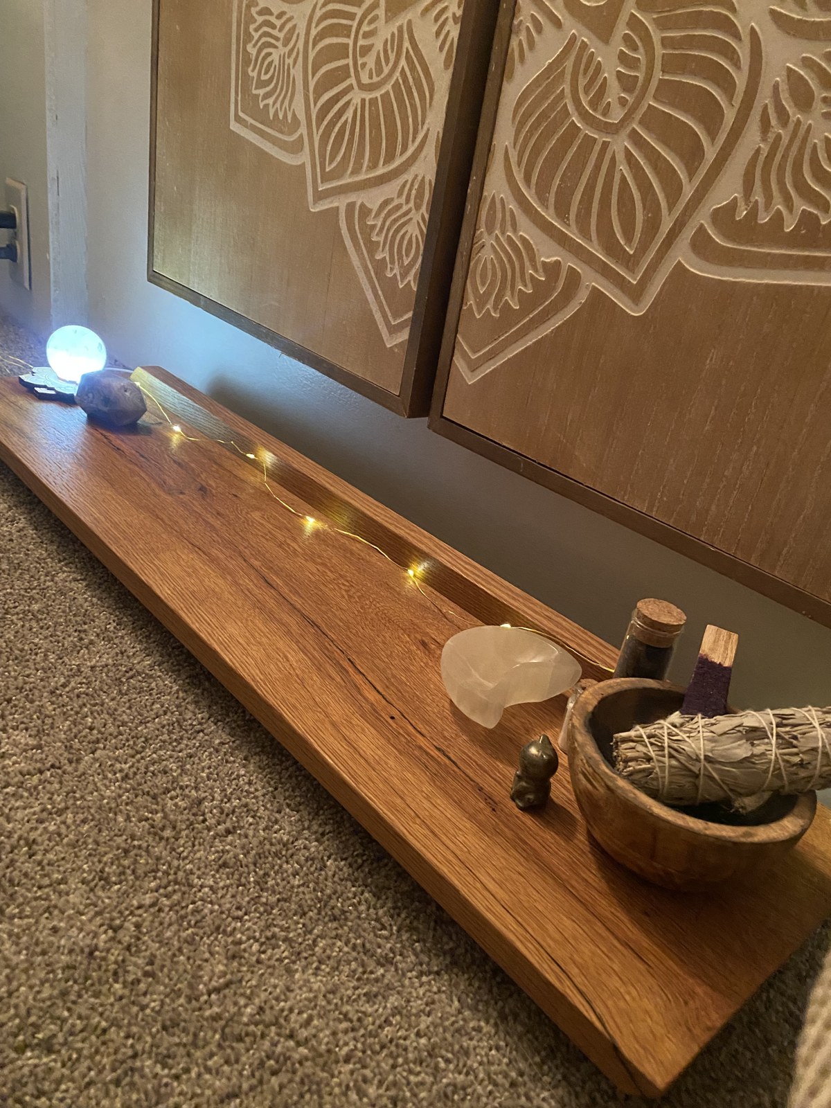 Custom wood altar with natural grain, crystals and warm lights